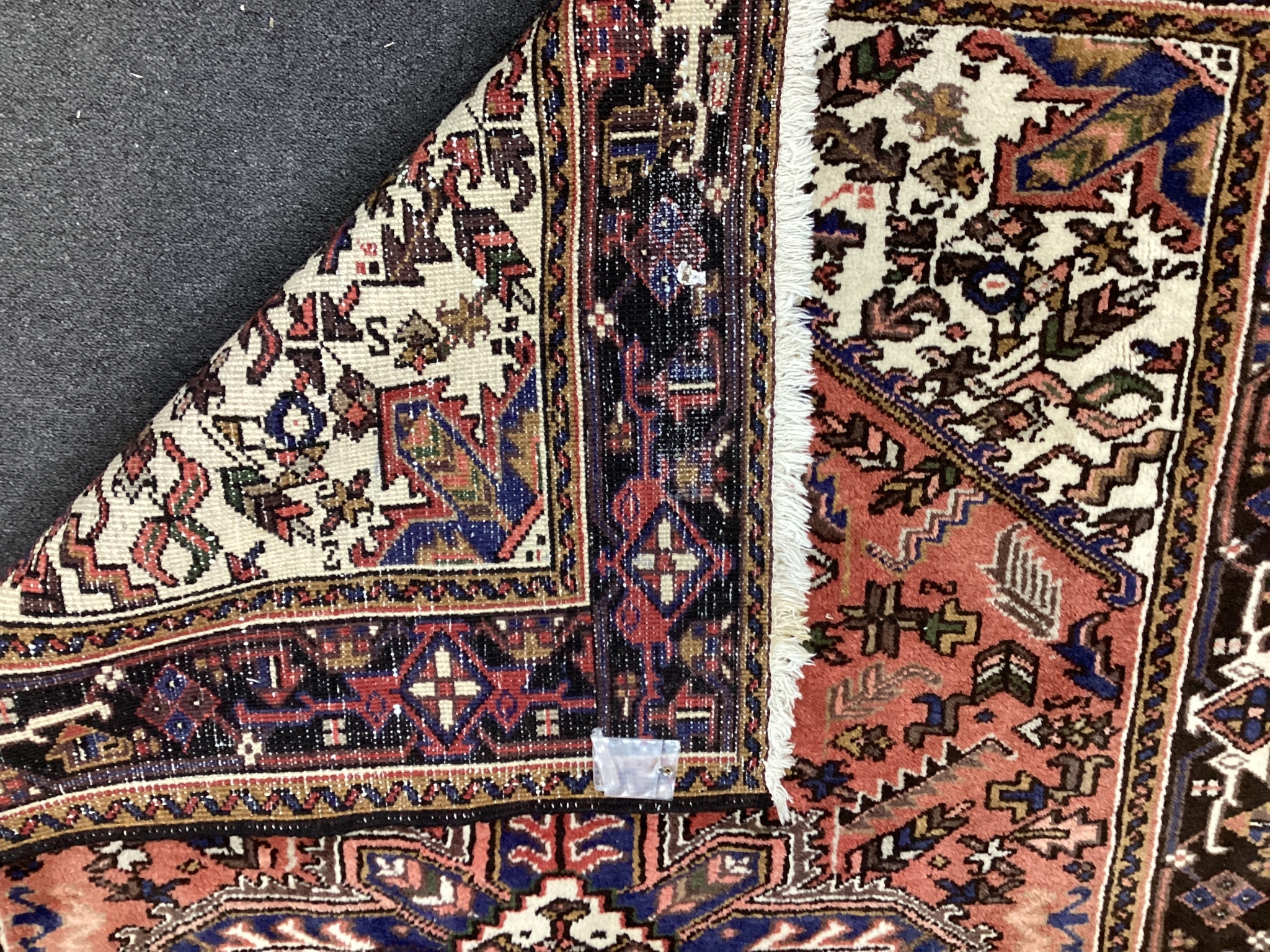 An Heriz red ground rug, 200cms x 148cms